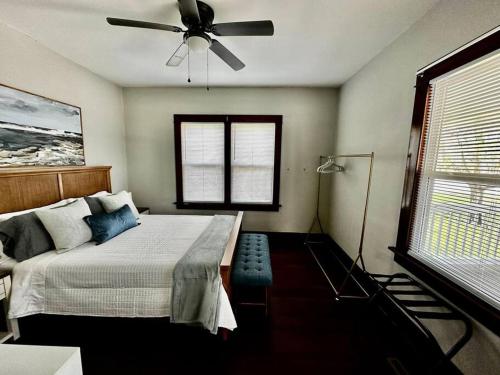 a bedroom with a bed and a ceiling fan at Mrs. Hughes Cottage - 2 bedroom House w/ parking in Hamilton