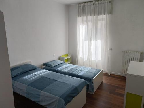 una camera con due letti e una finestra di Suite Bosco a Cisternino