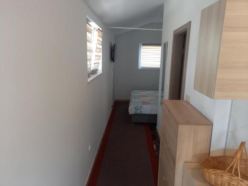a hallway with a room with a bed and a window at Studio Apartman Šutić in Kastel Novi