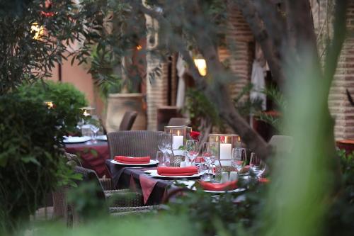 a table set with wine glasses and red napkins at La Maison Arabe Hotel, Spa & Cooking Workshops in Marrakech
