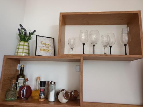 a shelf with wine glasses sitting on it at Apartments Sandra in Lovran