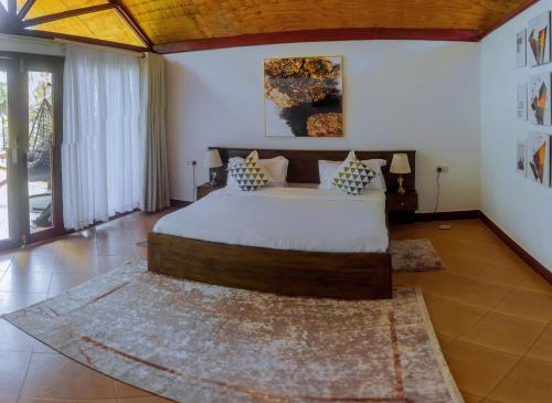 a bedroom with a large bed in a room at Shose Farmhouse Chalets & Campsite in Moshi