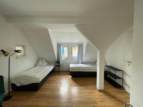 a attic room with two beds and a lamp at Ferienhaus Auerhahn in Vöcklabruck