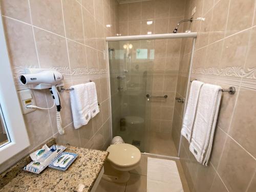 a bathroom with a shower with a toilet and a sink at Hotel Pousada da Neve in Nova Petrópolis