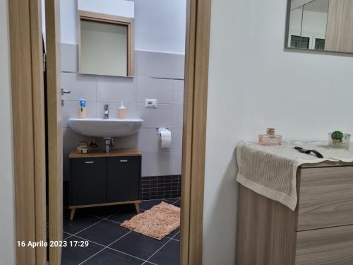a bathroom with a sink and a mirror and a sink at ADRIANA SEAHOUSE in Balestrate