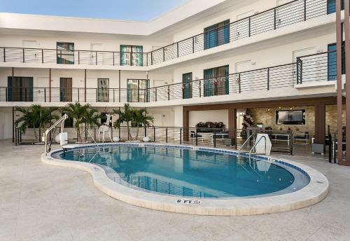 a large swimming pool in the middle of a building at Deco Boutique Hotel in Fort Lauderdale