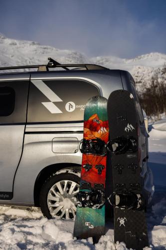 a pair of snowboards sitting on the back of a car at OsloCampervan in Oslo