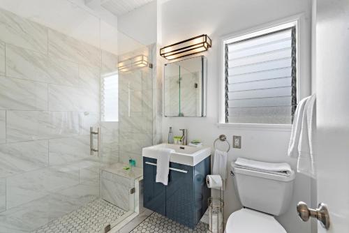 a white bathroom with a sink and a toilet at Sleepy Hollow Villas #2 in Laguna Beach in Laguna Beach