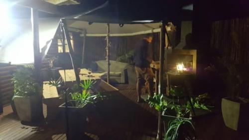 un hombre de pie en una habitación con plantas en JBay Surfed Out, en Jeffreys Bay