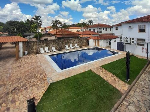 a swimming pool in the yard of a house at Pousada o Amanhecer in Tiradentes