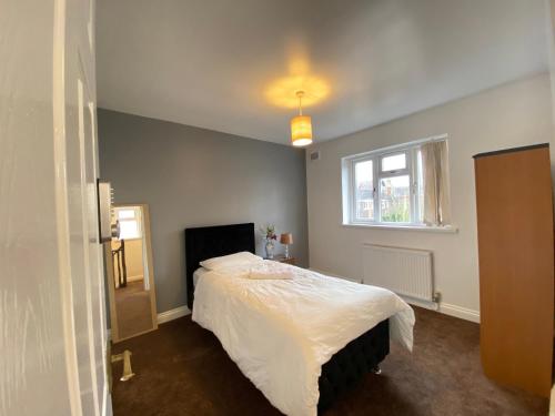 1 dormitorio con cama y ventana en budget private rooms close to city centre and airport, en Birmingham