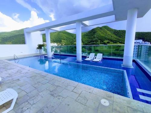 a swimming pool on the roof of a building at Hugos studio loft in Gaira