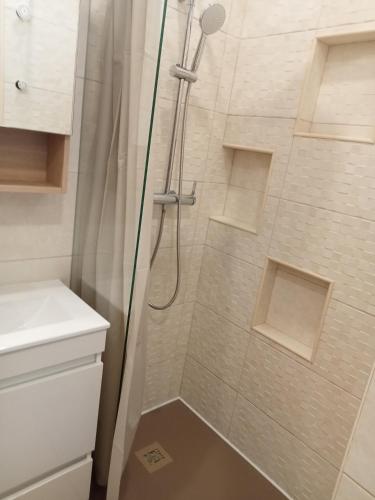a shower with a glass door in a bathroom at Porta Nova Guesthouse by R-Tex in Tavira