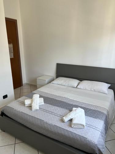 a bedroom with a bed with towels on it at Rho Fiera Apartment in Cornaredo