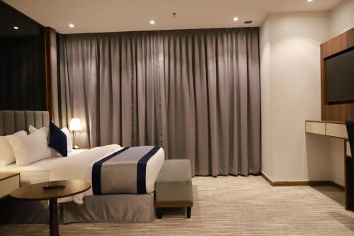 Katil atau katil-katil dalam bilik di Tulip View Hotel