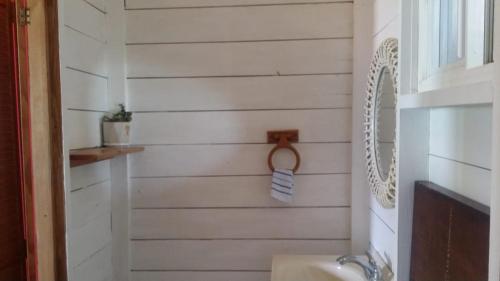 a bathroom with a sink and a mirror at Villa Rasta - Ocean View Bungalows in Port Antonio