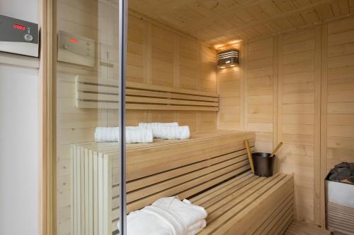 a sauna with white towels on a wooden wall at Imperium Luxury Villas-Sauna, Jacuzzi, Heated Pool & Gym-Chania in Kato Galatas
