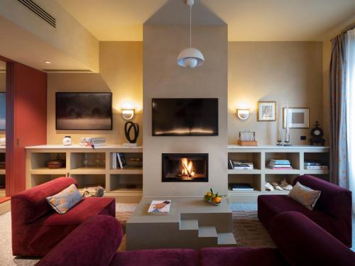 a living room with a couch and a fireplace at Paradis Pietrasanta in Pietrasanta