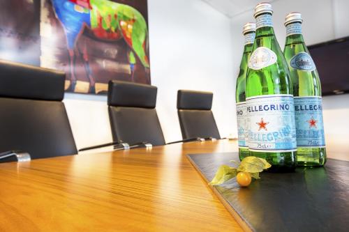 two bottles of wine sitting on a wooden table at Hotel Lautrup Park in Ballerup