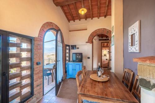 a kitchen and dining room with a wooden table and chairs at Agriturismo Podere Luisa in Montevarchi