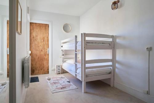 een kamer met 2 stapelbedden en een deuropening bij Superbe appartement, balcon vue mer, 3 chambres! in Bray-Dunes