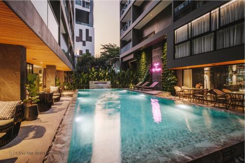 a swimming pool in the middle of a building at Cascade Hotel Bangkok in Bangkok