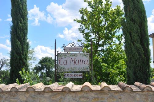 a sign that says ca marina behind a stone wall at Ca' Matra in Lama