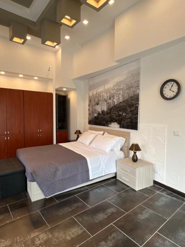 a bedroom with a bed and a clock on the wall at Casa Cicerone in Messina