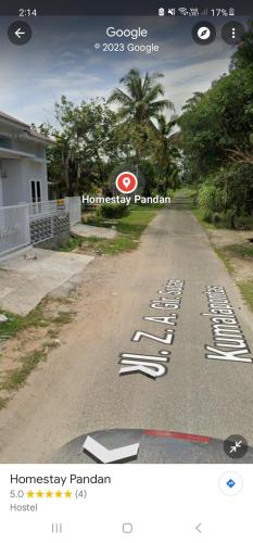 a road with a row of white signs on it at HOMESTAY PANDAN in Halangan