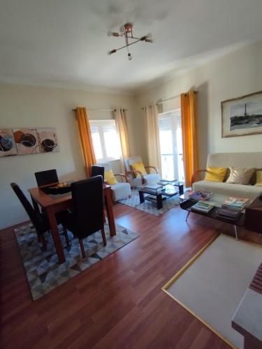 a living room with a table and a couch at Alameda Residence in Tomar