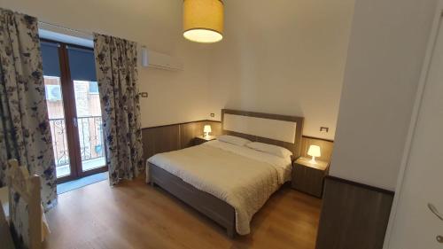 a bedroom with a bed and a large window at Casetta San Giorgio in Vallata