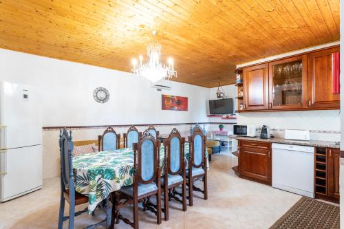 a kitchen with a table and chairs in a room at Casa Monteiro - Piscina Interior Aquecida in Santarém
