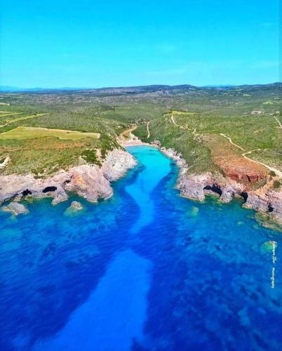 an aerial view of a river with blue water at Villa sul Mare Calalunga Calasetta Sant Antioco in Calasetta