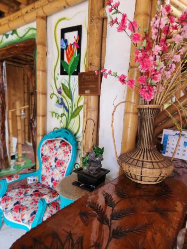 a table with a vase with flowers on it at Tatacoa Star Eco Hotel in Villavieja