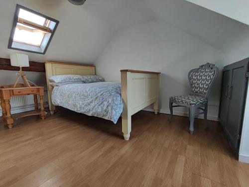 a bedroom with a bed and a desk and a chair at Ferguson's Traditional Townhouse in Dunkineely