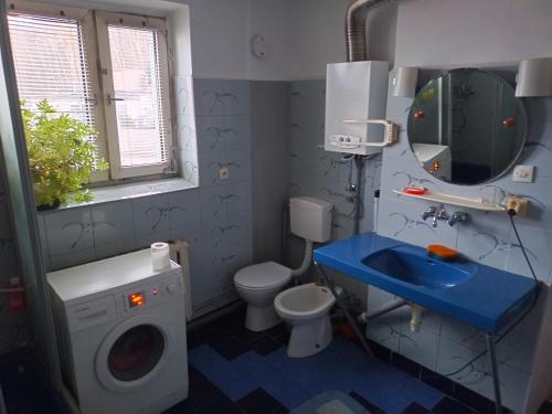a bathroom with a washing machine and a sink at Safari house - dom podróżnika in Gdynia