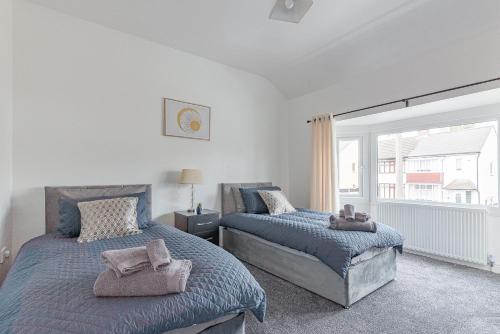 - une chambre avec 2 lits et une fenêtre dans l'établissement Beautiful 3 bedroom House near West Bromwich -contractors, Family, NHS, 