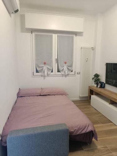 a bedroom with a bed and two windows at Lucania25 in Milan