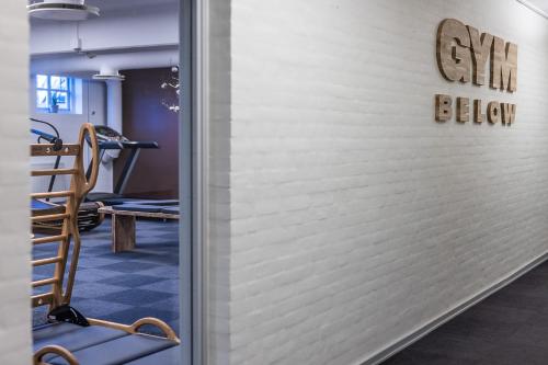 a gym with a white wall with a sign on it at The Lodge Billund in Billund