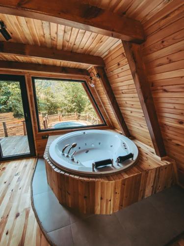 a large wooden room with a large tub in a cabin at Loca Sapanca Bungalov in Sapanca