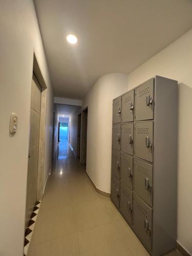 a row of lockers in a hallway with a corridor at Hostal Casa San Pedro in Santa Marta