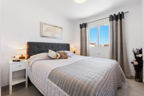 Punta PrimaにあるCB Living - Bright bungalow in Punta Primaのベッドと窓のある白い寝室