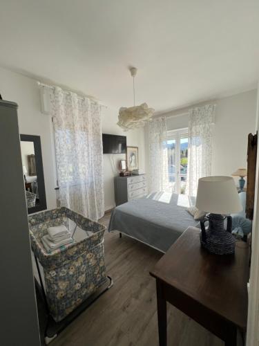 una camera con letto, sedia e tavolo di La Pitorina Holidayhome a Camaiore