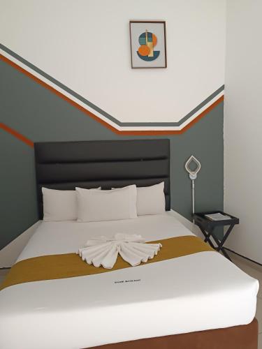 a bedroom with a large white bed in a room at Shalakwe Hills-Inn Guesthouse Kasane in Kasane