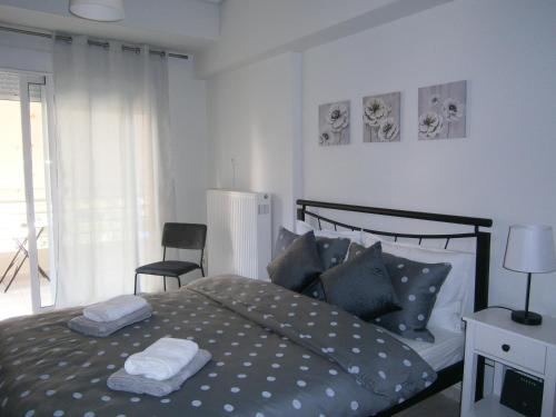 a bedroom with a bed with two towels on it at Volos Studio Stella in Volos