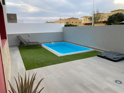 a swimming pool on the roof of a house at Villa Inda in Gran Tarajal