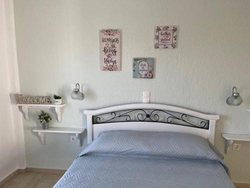 een slaapkamer met een bed en drie foto's aan de muur bij Villa Rena in Istron