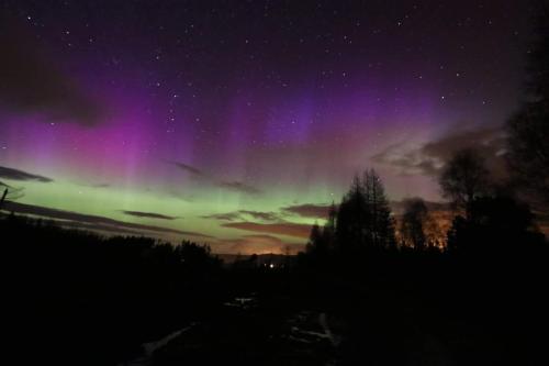 an aurora in the sky at night at Stylish Garden Flat Near Loch Ness in Drumnadrochit