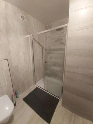 a shower stall in a bathroom with a toilet at La belle Éden Gite Bastogne in Bastogne
