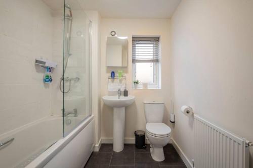 a bathroom with a toilet and a shower and a sink at Hemsworth Double Bedroom with Private Bathroom in Hemsworth